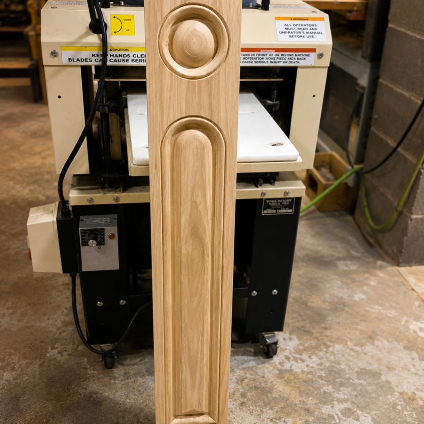 Carved wooden post on a machine in the shop